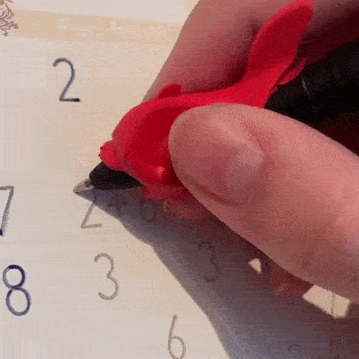 A child traces numbers in the groove with the grip on the pen