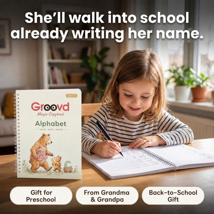 A girl writing her name in the copybook