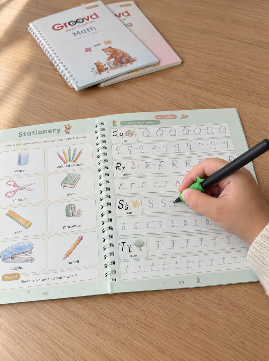 A child traces the grooved letter S in the Alphabet copybook with the black magic pen and green dolphin grip