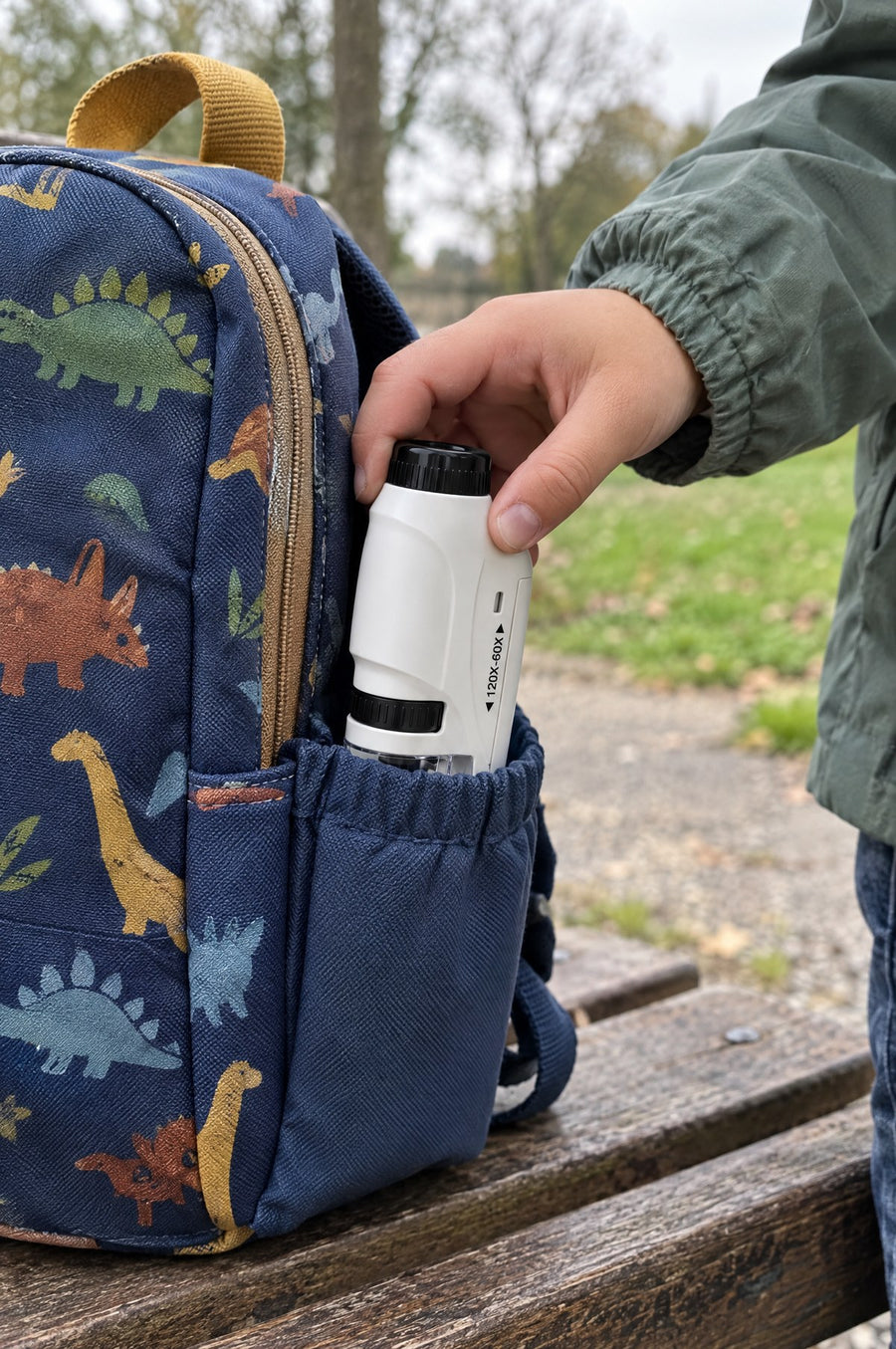 The Miniscope in a backpack side pocket on a park bench