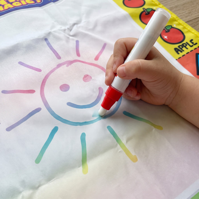 AquaDoodle mat: a child's hands drawing