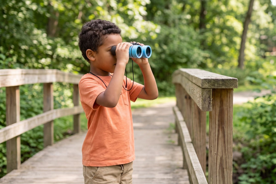 A child playing with the Little Explorer Binoculars