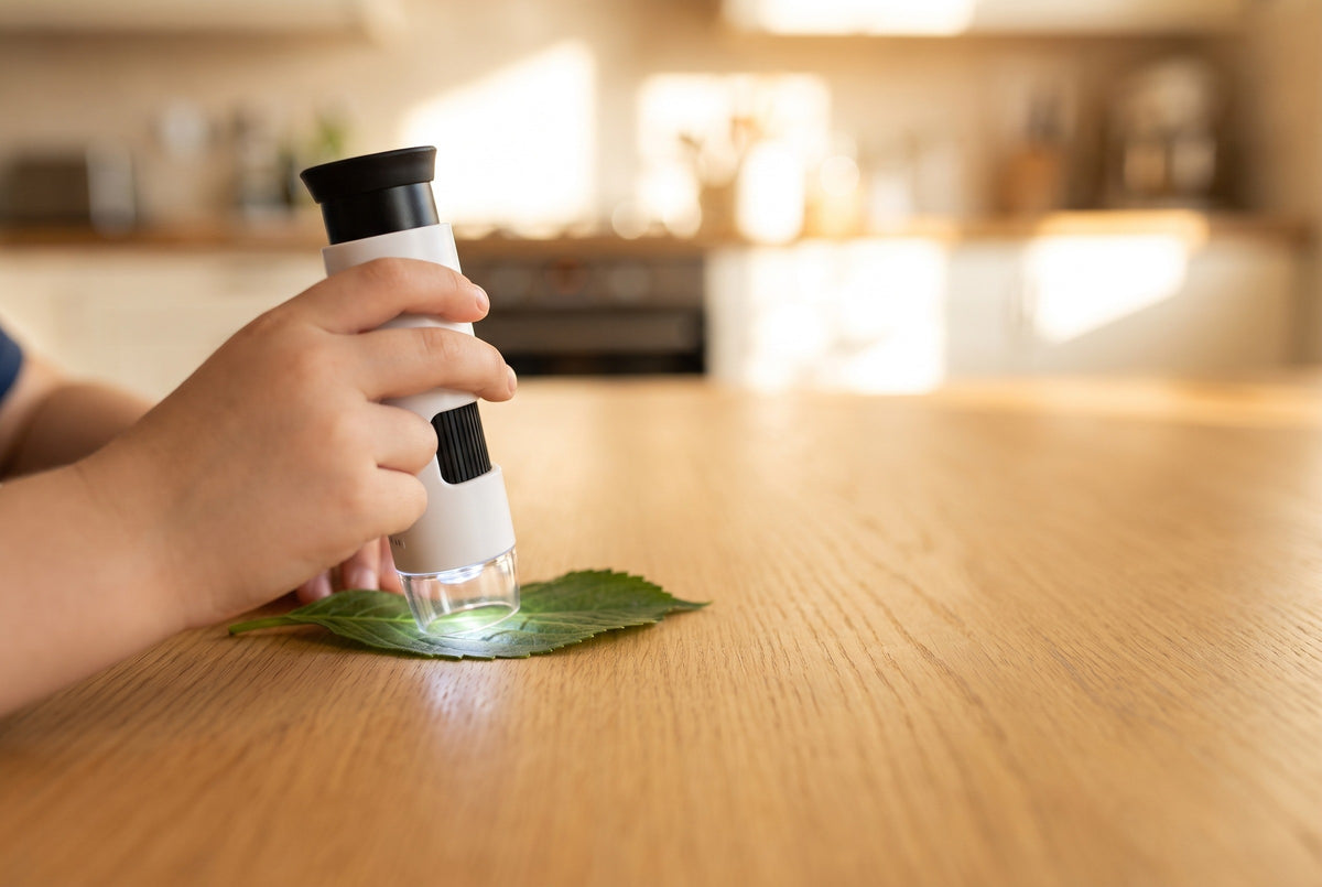 A child holds the Miniscope on a leaf
